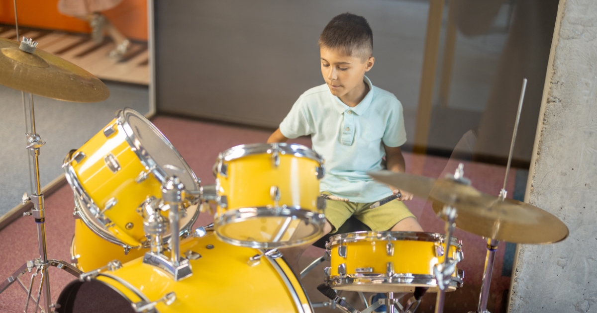 a boy playing a drum during homeschool