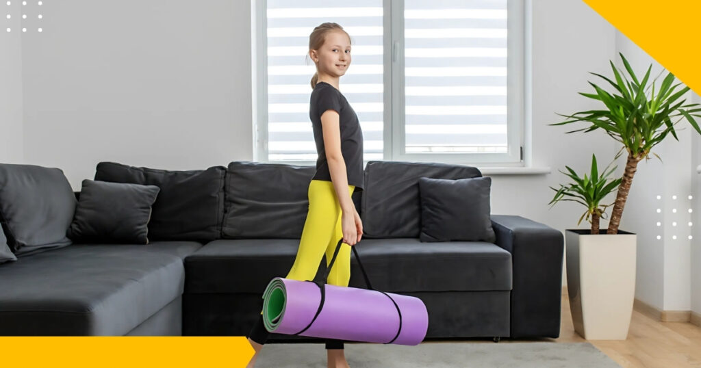 A young girl in yellow leggings and a black top standing in a modern living room, holding a purple yoga mat, ready for a yoga or mindfulness session. The room features a black sofa and potted plants.