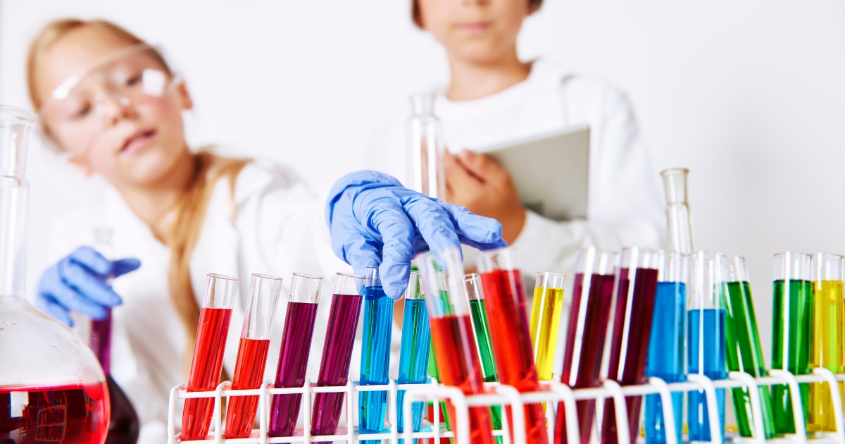 oung students conducting a colorful science experiment with test tubes in a homeschool lab.