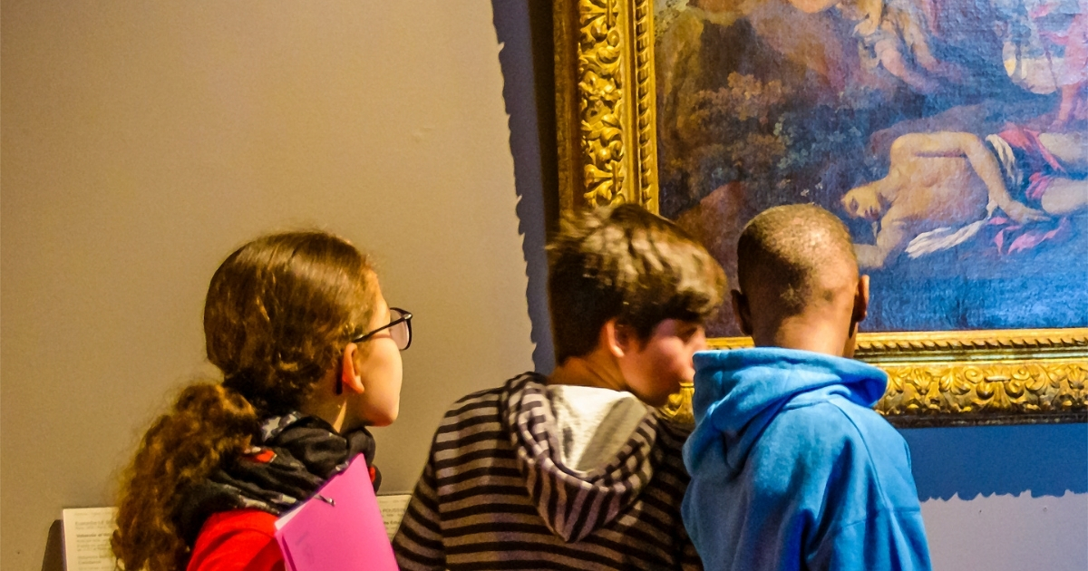 Homeschool students closely examining a historical painting in a museum, engaging in an educational field trip to enhance their history learning.