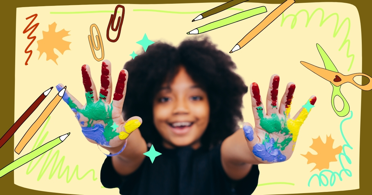 Smiling child with colorful painted hands, surrounded by creative art supplies, representing hands-on creativity and artistic expression for kids.