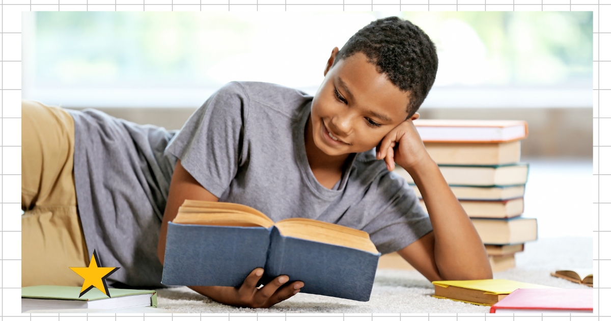 Smiling homeschool student reading a book, surrounded by stacks of books, engaging in unplugged learning.